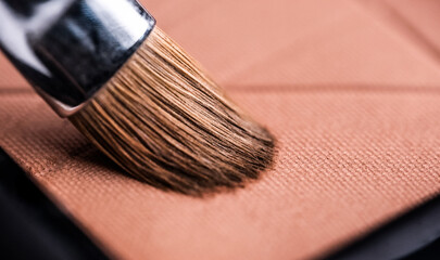 Makeup brush and set of pastel shadows