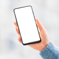 Hand holding mobile phone with white screen