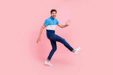 Fototapeta na wymiar Full length profile photo of lovely brunet young guy dance wave wear polo jeans sneakers isolated on pink background