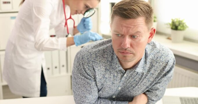 Doctor proctologist taking out toy car from rectum of male patient 4k movie slow motion