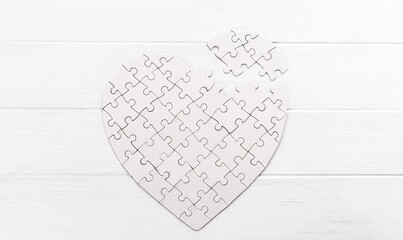 White jigsaw puzzle in form of heart