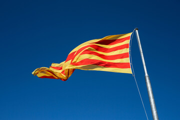 Flag of Catalonia. Against the blue sky