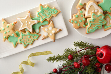 Two plates with christmas cookies decorated with icing top view