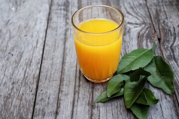 Orange juice and fruit on wood background