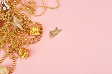 Golden christmas decorations on pink background. Christmas New year or party banner. Copy space