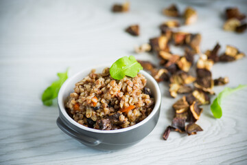 boiled buckwheat with vegetables and dried forest mushrooms in a ceramic mold
