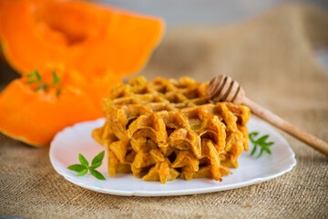 sweet baked pumpkin waffles with honey in a plate