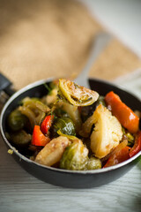 fried brussels sprouts with cauliflower and other vegetables in a frying pan