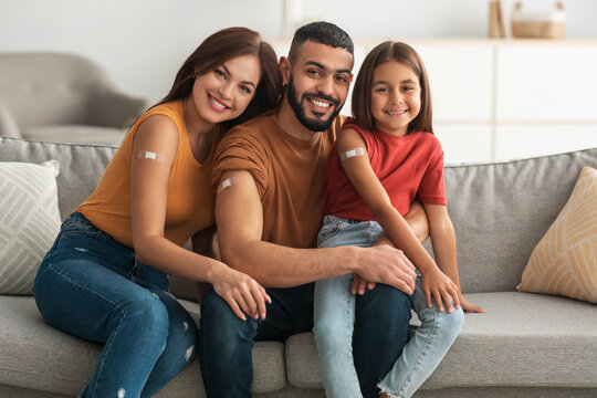 Happy Vaccinated Family Showing Adhesive Bandage After Vaccine