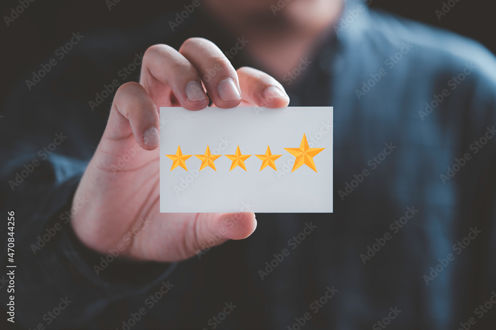 Poster businessman holding white paper with five yellow stars for client evaluation and customer satisfacti