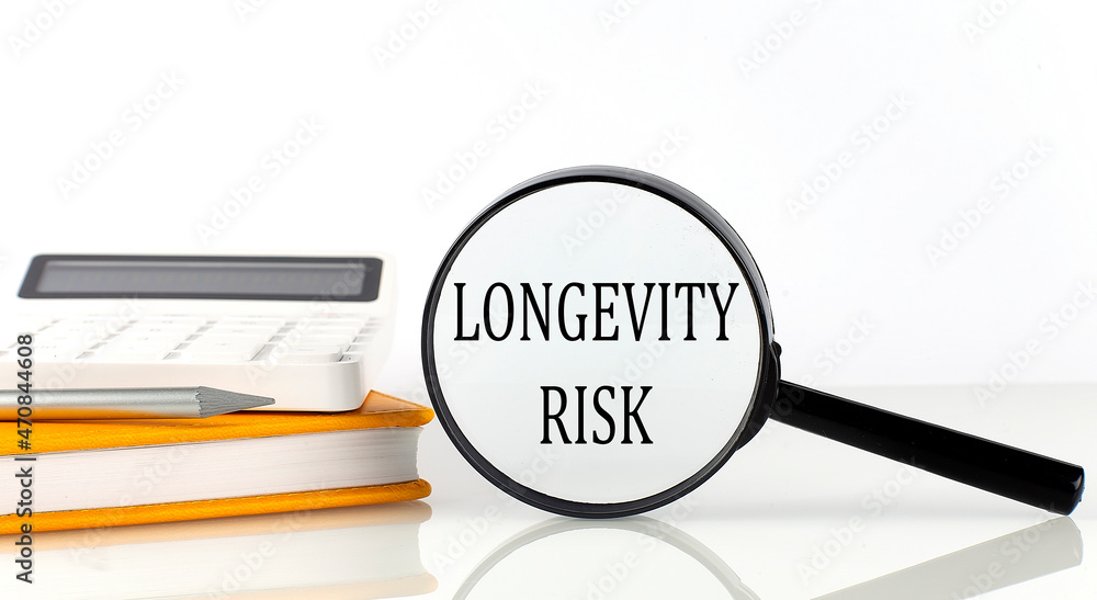 Poster magnifier with text longevity risk with notebook, calculator on the white background