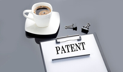 PATENT text on the paper sheet with coffee on the black background