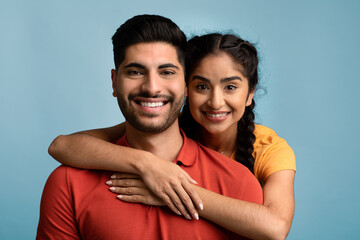 Obraz premium Happy Arab Couple. Portrait of Cheerful Middle Eastern Man And Woman Hugging