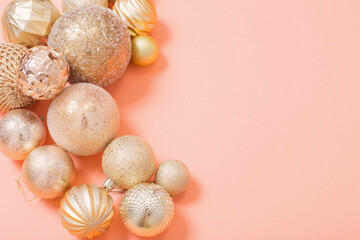 golden christmas balls on orange paper background