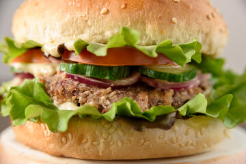 Vegetarian burger with bean patty on wooden table close up