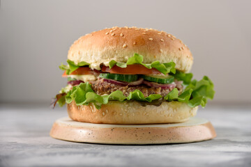 Vegetarian burger with bean patty on grey concrete background