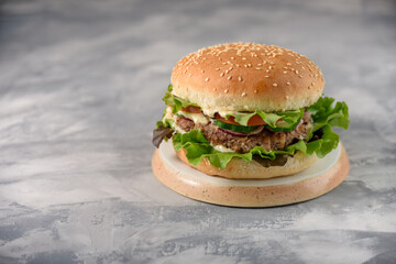 Vegetarian burger with bean patty on grey concrete background
