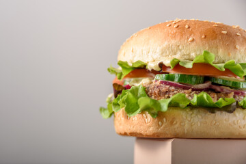 Vegetarian burger with bean patty on cube. Epic hero view from below, close up