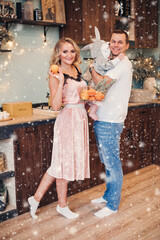 Beautiful lady with her child and husband in deocrated kitchen