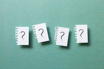 Question mark on ripped note on green background. Thinking, solution, business, idea concept