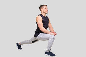 Sport man Warming Up. Pre workout Warm up. Man Doing Excersises Isolated. Man Stretching. Sportman Stretching