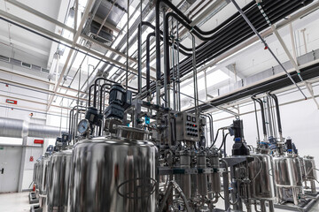 Photo of pipes and tanks. Chemistry and medicine production. Pharmaceutical factory. Interior of a...