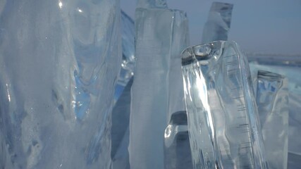 Dolly close up transparent sparkling clear ice blocks, icebergs hummocks on deepest winter frozen lake Baikal. Siberia Russia natural landscape details. Abstract North Arctic stock movie. Beautiful 4k - Powered by Adobe