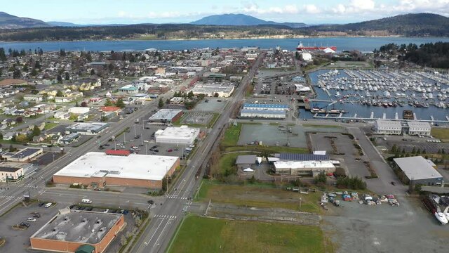 Cinematic 4K aerial drone pan shot of Anacortes Midtown, Old Town, waterfront, Guemes Island, Cypress Island in the San Juan Islands, Washington