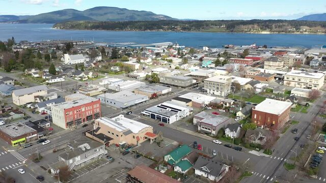 Cinematic 4K aerial drone dolly shot of charming historic Anacortes Midtown, Old Town, waterfront, Guemes Island, Cypress Island in the San Juan Islands, Washington