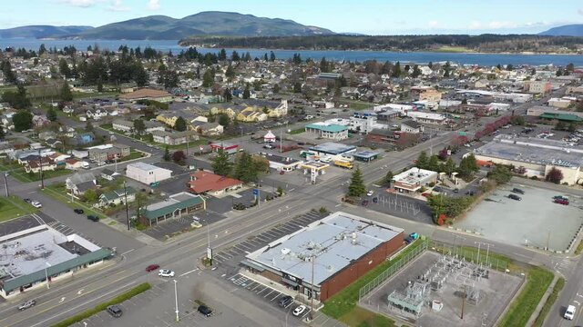Cinematic 4K aerial drone pan shot of Anacortes Midtown, Old Town, waterfront, Guemes Island, Guemes Channel, Cypress Island in the San Juan Islands, Washington