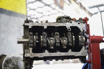 the hand of a mechanic is installing the valve seal of an overhauled car engine