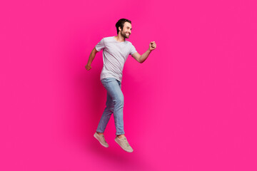 Profile photo of sportive guy jump run jogging trainer wear striped t-shirt jeans sneakers isolated pink color background