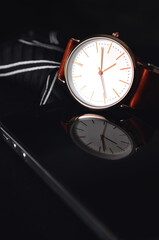 Men's watch with a tie on a dark background. Elegant watches