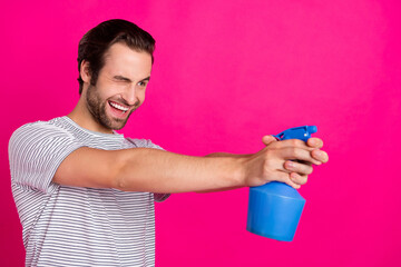 Profile photo of crazy funny playful childish guy aim pulverizer shot wear grey t-shirt isolated pink color background