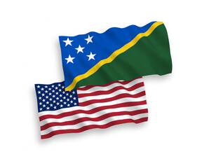 Obraz premium National vector fabric wave flags of Solomon Islands and USA isolated on white background. 1 to 2 proportion.