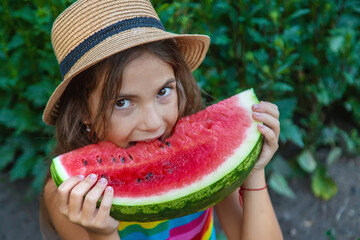 The child eats watermelon in the summer. Selective focus.