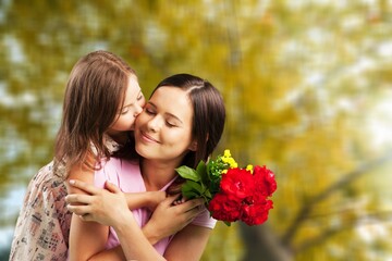 Fototapeta premium Happy mother and daughter having a good time outdoors in city park