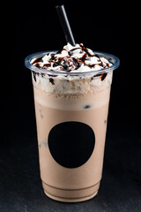Iced coffee with cream and sauce in take away cup mock up isolated on black background