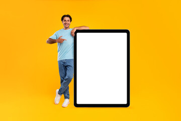Guy pointing and leaning on big white empty tab screen