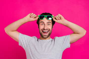 Photo of young cheerful guy eyesight astonished great news discount isolated over magenta color...