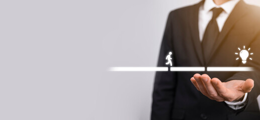 Male business man hand hold a connecting block between two sets of bridge road for a silhouetted man to walk idea icon.