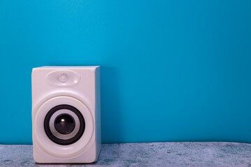 white audio speaker on blue background
