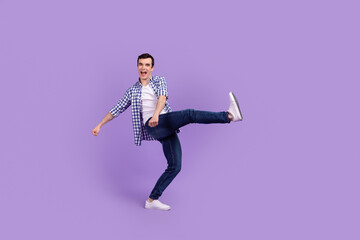 Full length profile side photo of young guy good mood dance party fooling isolated over violet color background