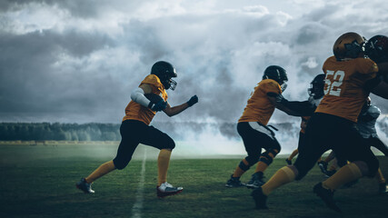 American Football Field Two Teams Play: Successful Player Running Around Defense Players to Score Touchdown Points. Professional Athletes Compete for the Ball, Fight for Victory.