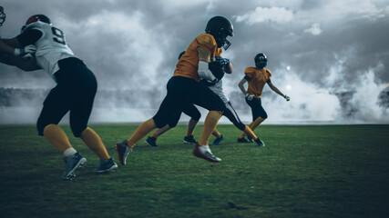 American Football Field Two Teams Play: Successful Player Running Around Defense Players to Score...