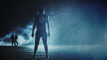 American Football Field: Lonely Athlete Warrior Standing on a Field Holds his Helmet and Ready to...