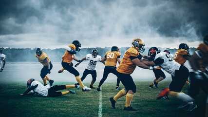 Fototapeta na wymiar American Football Teams Playing Game: Professional Players, Aggressive Face-off, Tackle, Pass, Fight for Ball and Score. Warrior Competition Full of Brutal Energy, Power, Skill.