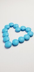 Blue heart made of pills. Heart pills. Vitamins for adults, children, pregnant women. Heart shaped blue pills.
