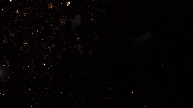 Handheld shot of firework in the sky during the night during the diwali festival in India. People celebrating diwali festival by bursting crackers. Fireworks in sky during diwali background.	