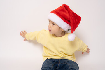 Cute little boy wearing santa hat isolated over white background.